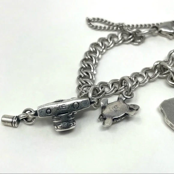 JAMES AVERY sterling silver charm bracelet, 8 charms Bracelets